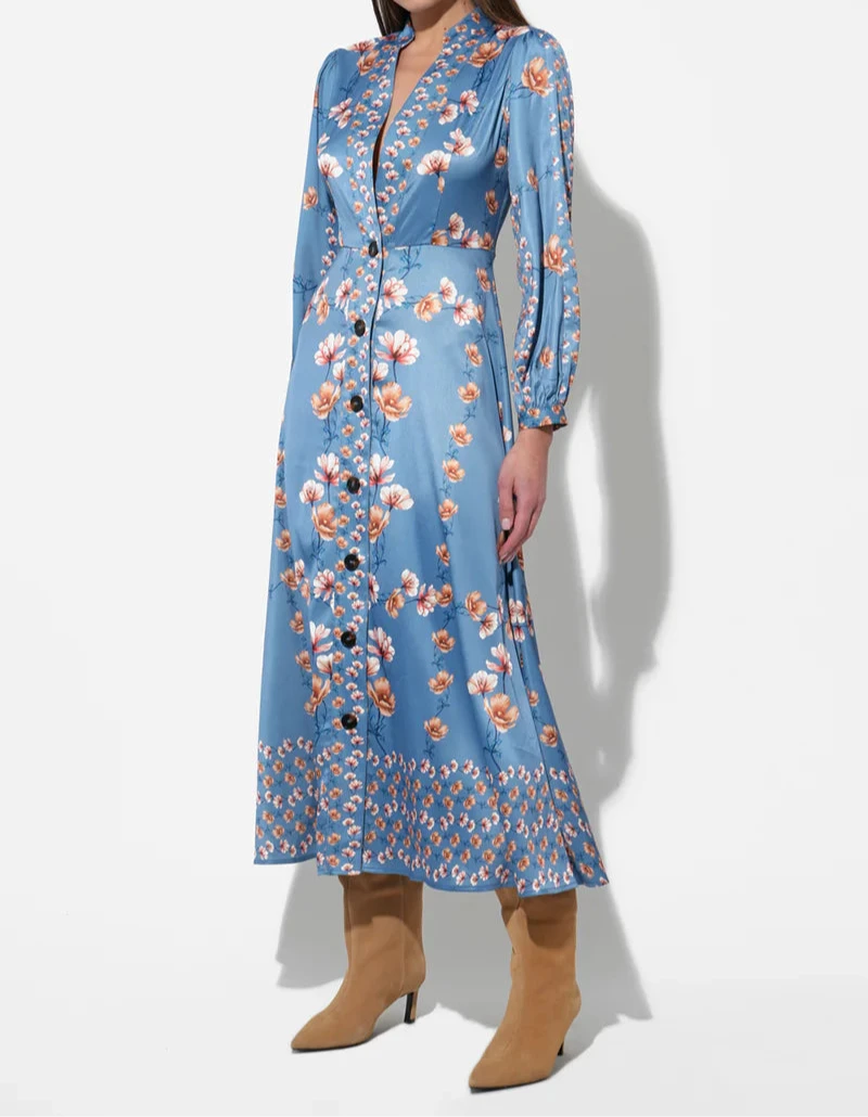 Model wearing Hazel Blue Jailyn Button-Front Midi Dress by Adelyn Rae, featuring long sleeves, V-neckline with mandarin collar, and orange floral print on satin-finish fabric.
