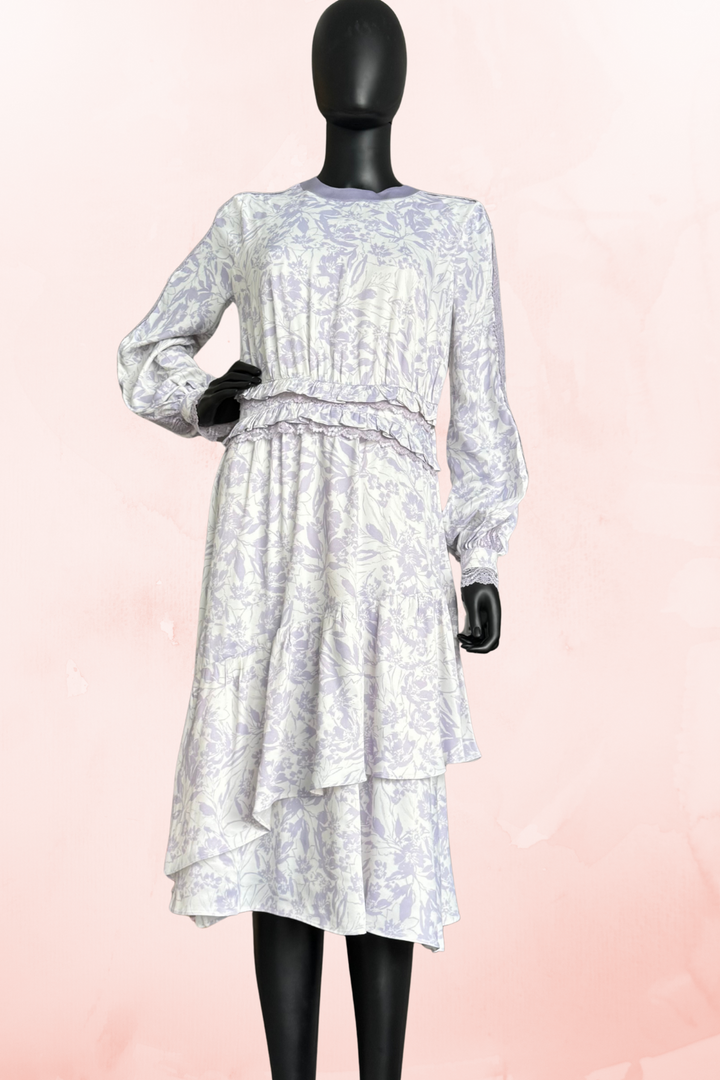 Lilac floral midi dress by Qui Prive featuring long sleeves, a modest crew neckline, tiered skirt detail, and elegant floral print, perfect for daytime events.