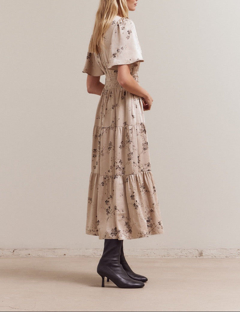 Right side profile of the floral tiered midi dress featuring the elastic smocked waist and easy drape.