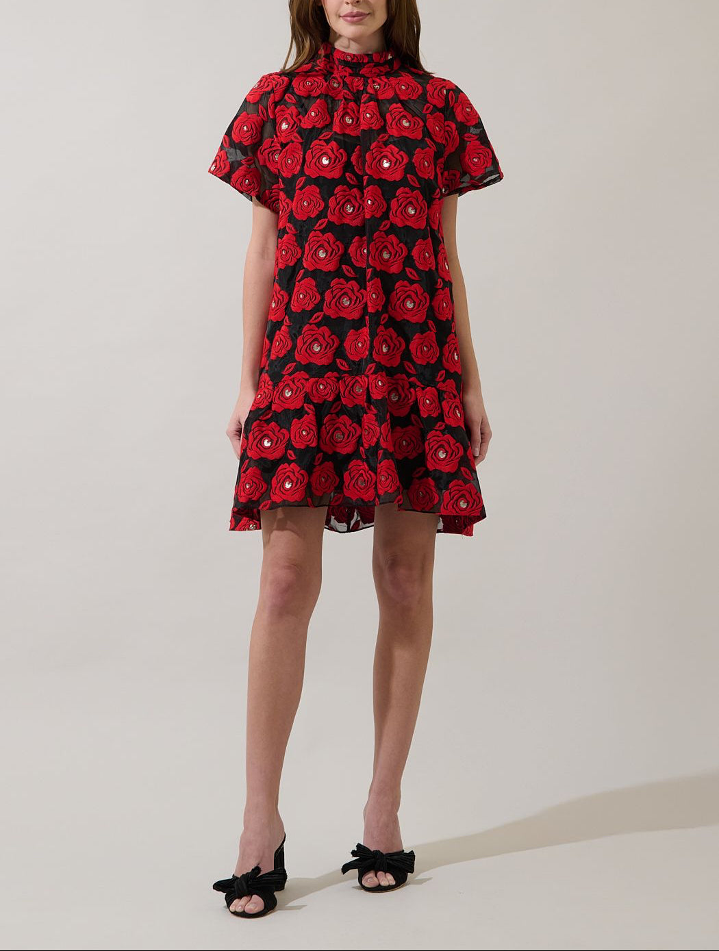 Full-length view of Sugarlips Berny red and black floral mini dress styled with black bow heels
