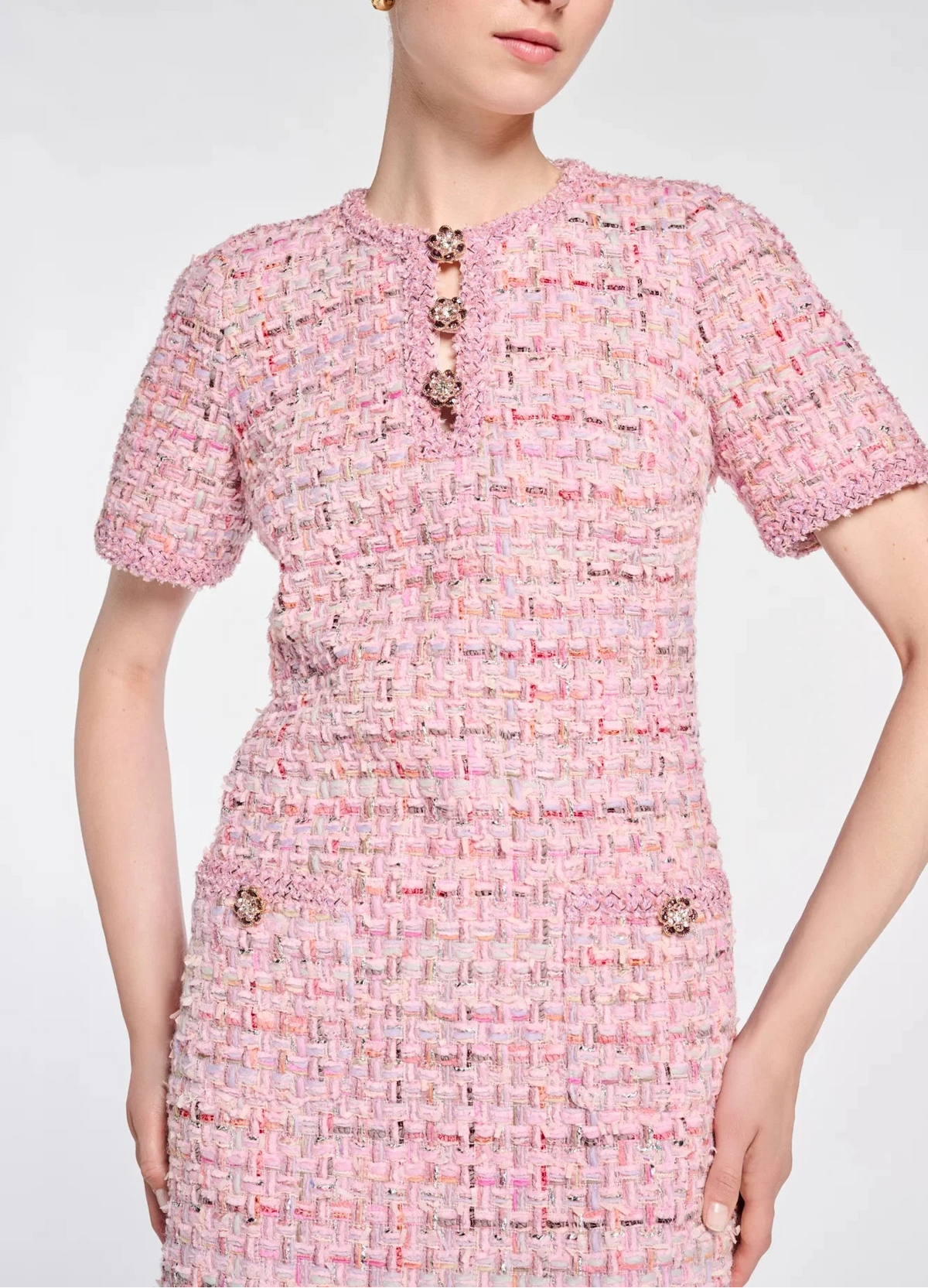 Close-up of floral jeweled buttons, pink braided trim and multicolor tweed on a Weill Paris dress.