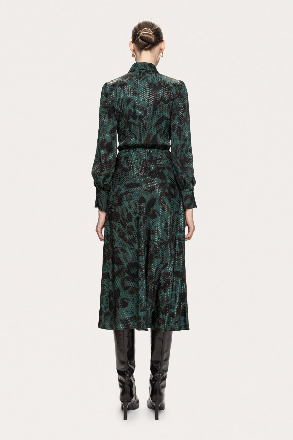 Back of NISSA green botanical print midi dress with a gathered waist and long cuffed sleeves.