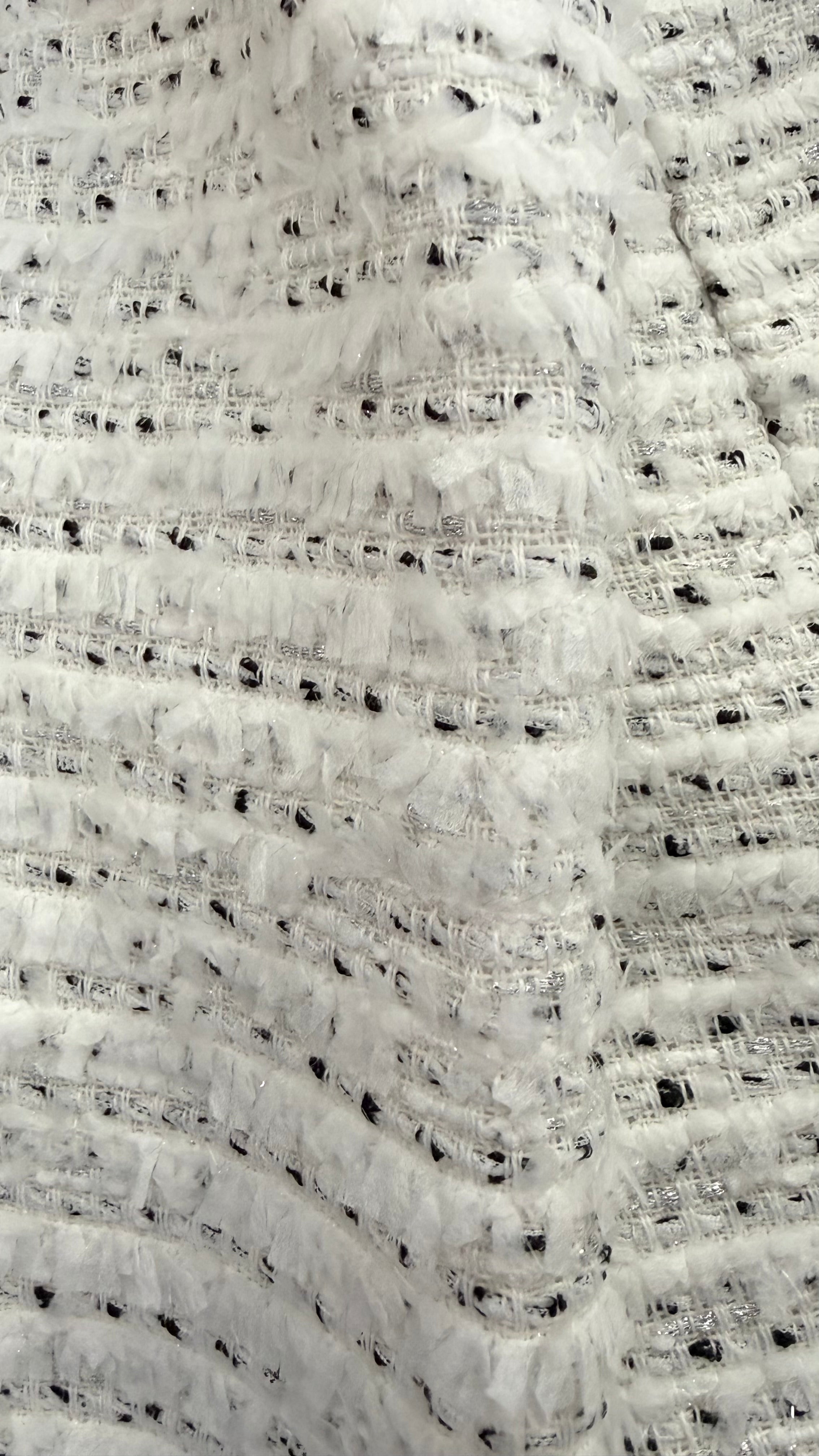 Close-up of the ivory bouclé tweed fabric on the Weill Paris jacket showing black flecks and textured weave detail