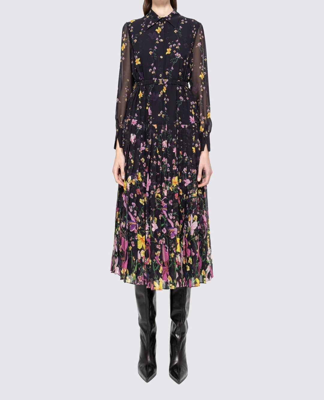 Model wearing black floral collared midi dress with belt, button front and pleated skirt