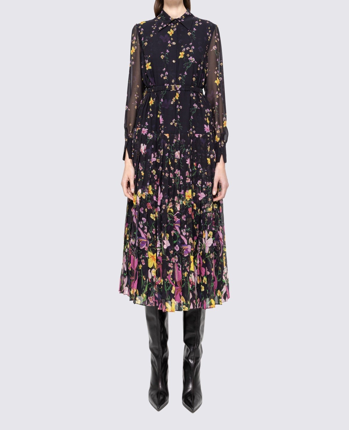 Model wearing black floral collared midi dress with belt, button front and pleated skirt