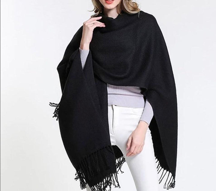 Front view of black fringe poncho shawl, soft knit wrap with asymmetrical drape