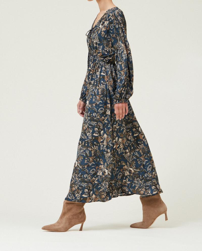 Walking side view of Dark Steel floral printed midi dress with long sleeves