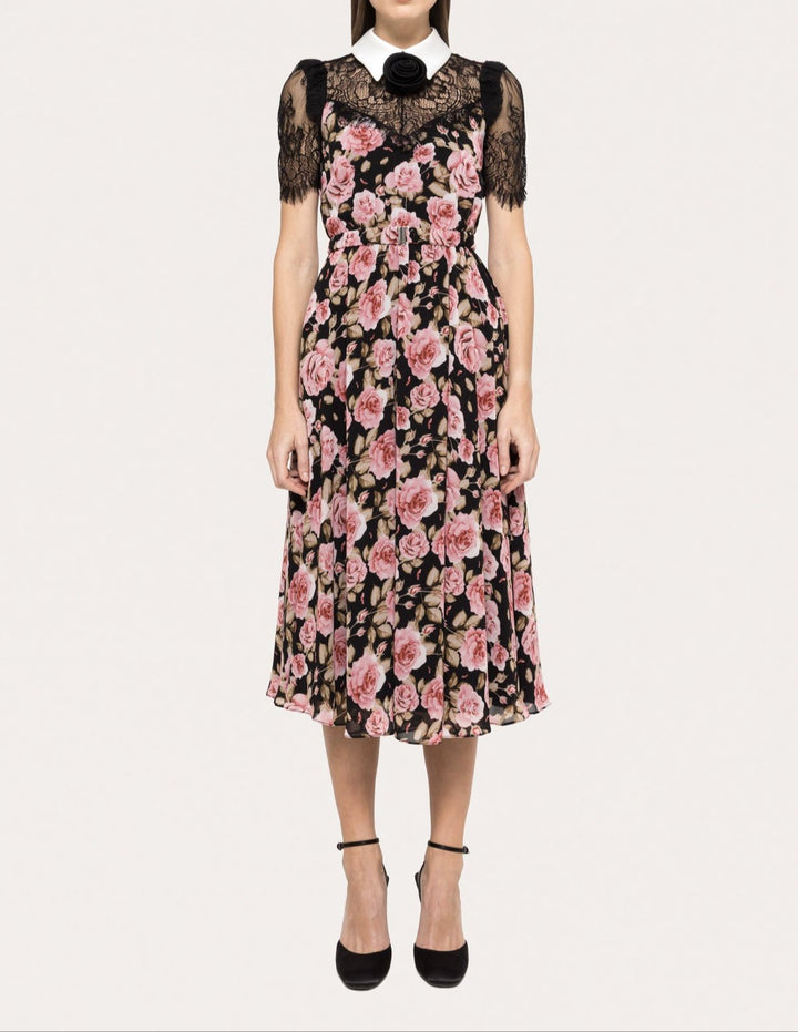 Model wearing black chiffon midi dress with pink rose print, black lace sleeves, and white collar by NISSA - BTK COLLECTIONS