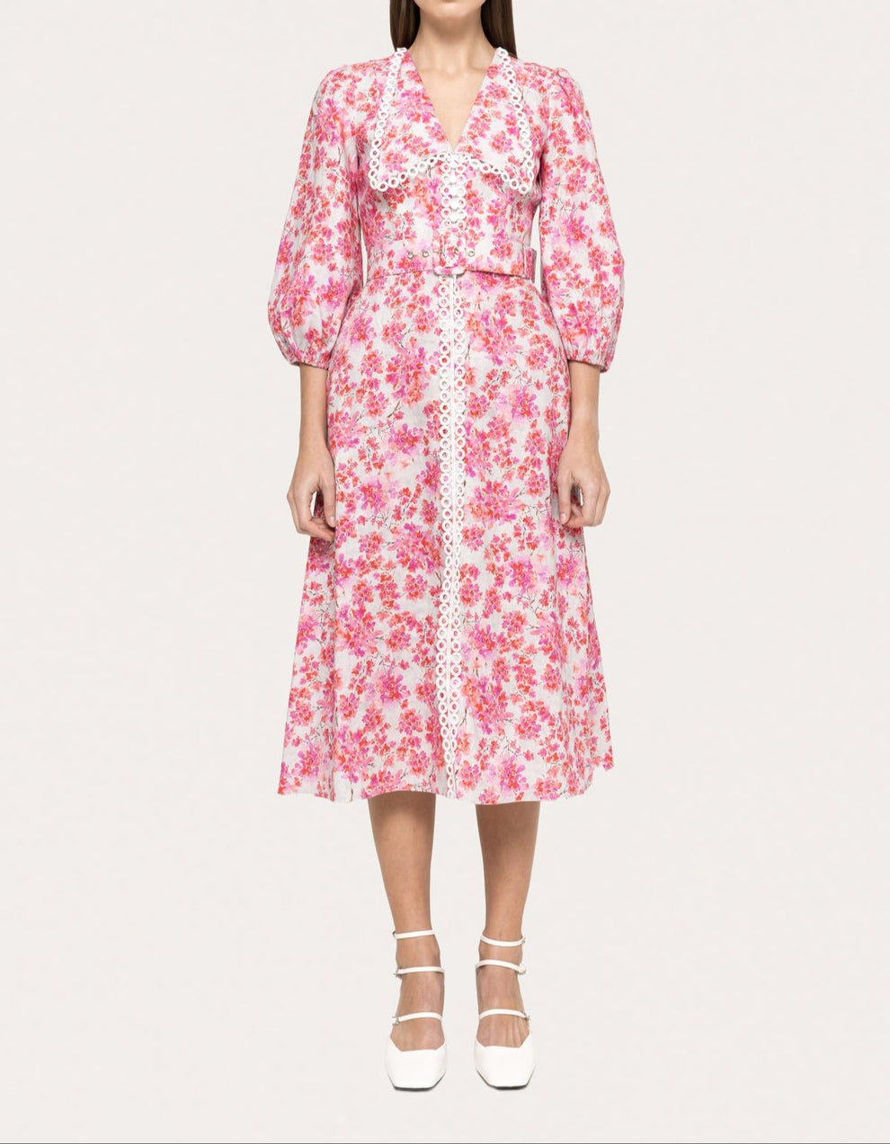 Model wearing pink floral linen midi dress with 3/4 puff sleeves, white lace trim, and belted waist by NISSA- BTK COLLECTIONS