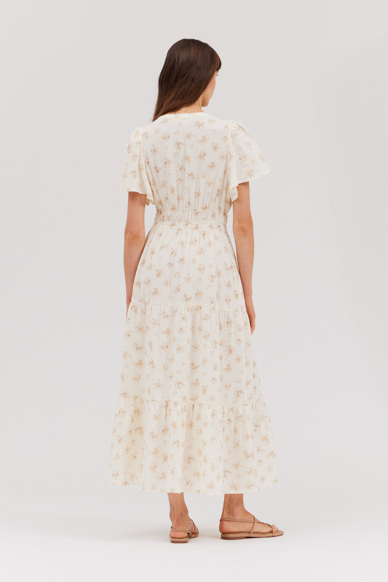 Back side profile showing the easy drape and textured cotton‑gauze of the floral midi dress.