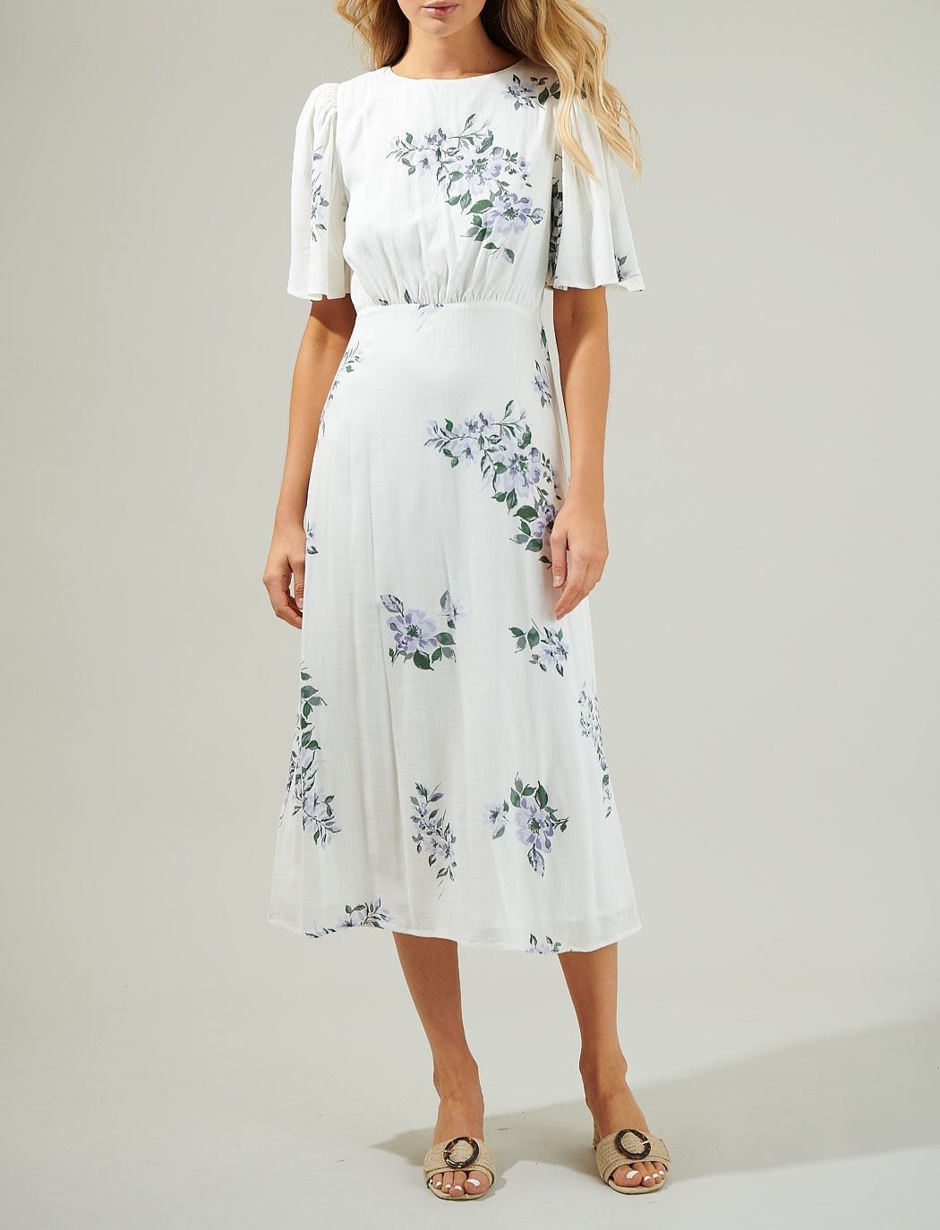 Front view of the Porto Floral Smocked Midi Dress by Sugarlips in white with purple florals