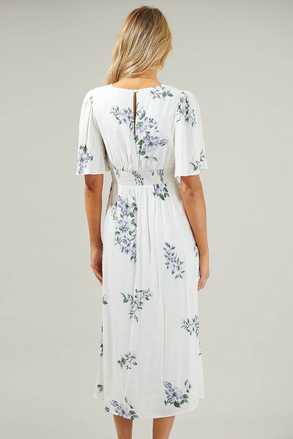 Back view of flutter sleeve white floral midi dress with smocked waist