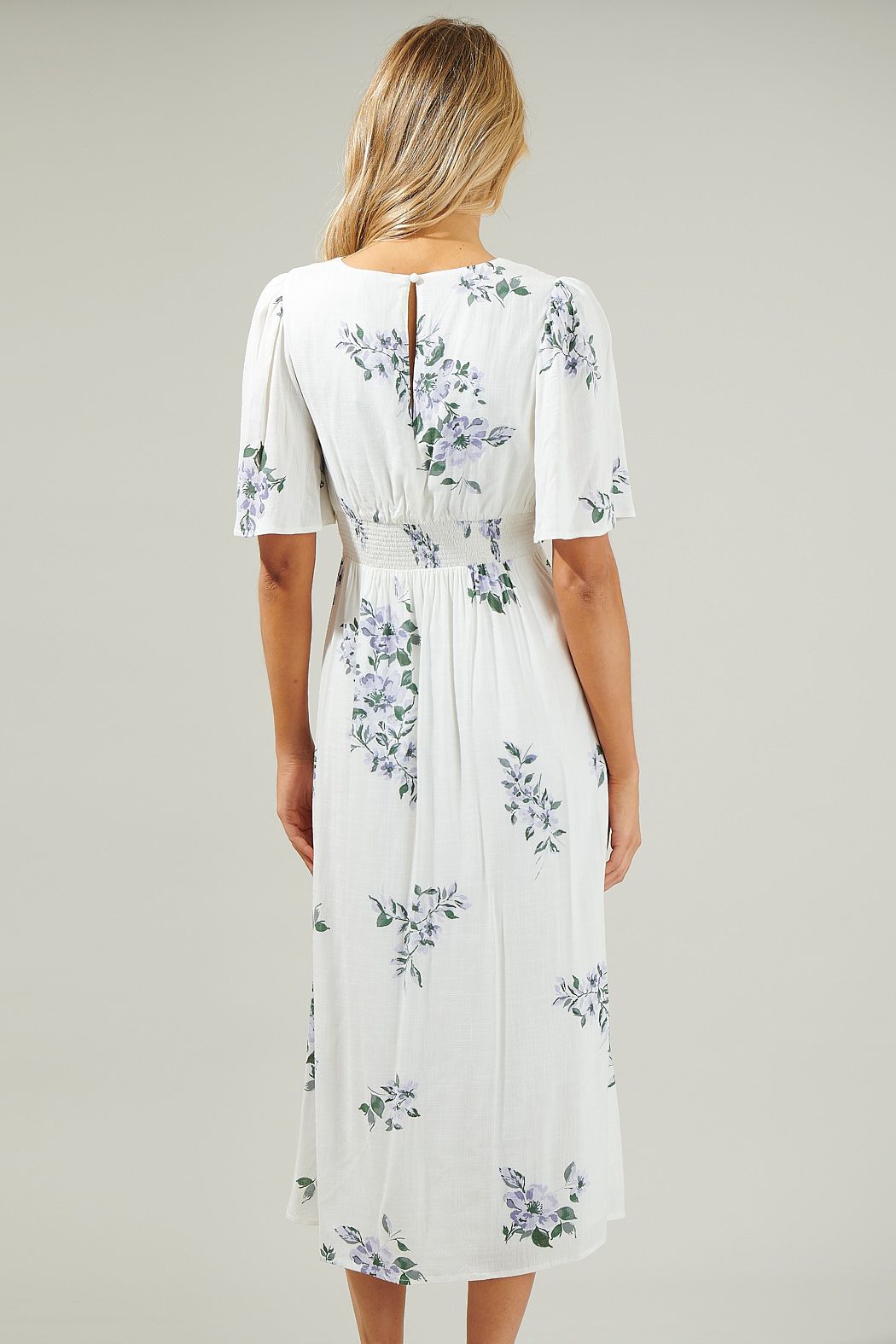 Back view of flutter sleeve white floral midi dress with smocked waist