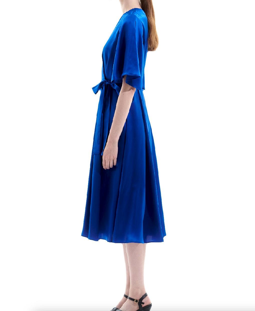 Side view of royal blue silk satin wrap midi dress with fluid drape and elbow length sleeves