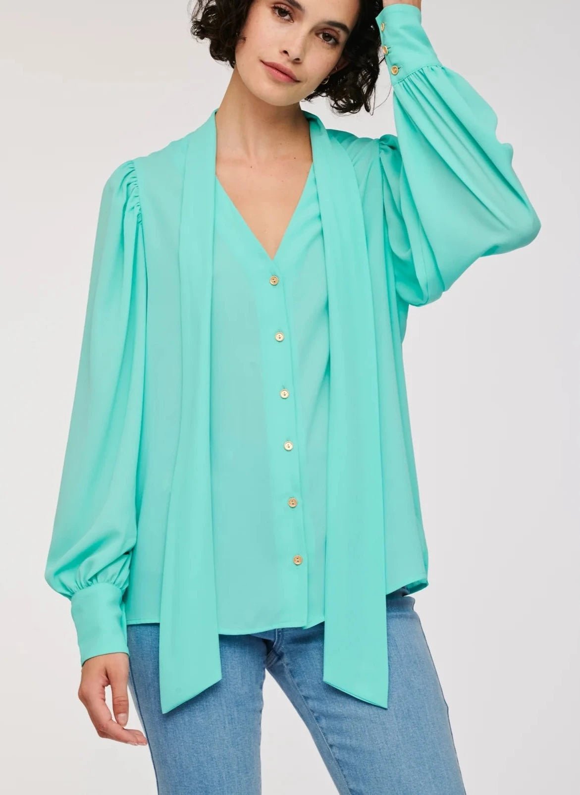 Front detail of WEILL turquoise blouse showing V-neck opening, long neck ties and gold-tone button fastening