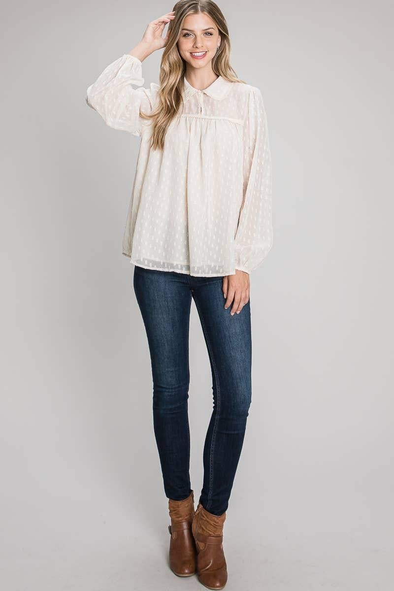 Model wearing the Champagne collared jacquard blouse with blue jeans and brown ankle boots.