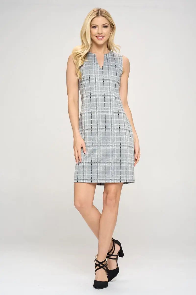 Full-length front view of Renee C grey plaid above-knee dress styled with black strappy heels.