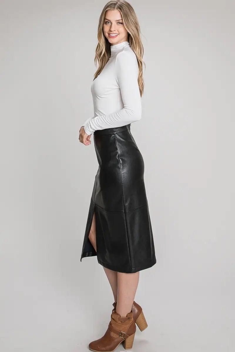Angled view of black faux leather midi skirt showing the fitted silhouette and front slit.