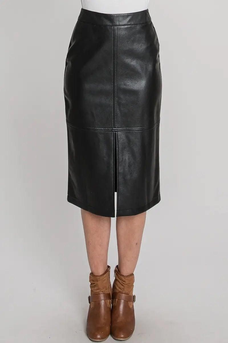 Close-up of black faux leather skirt showing the waistband, stitched panels and front slit.