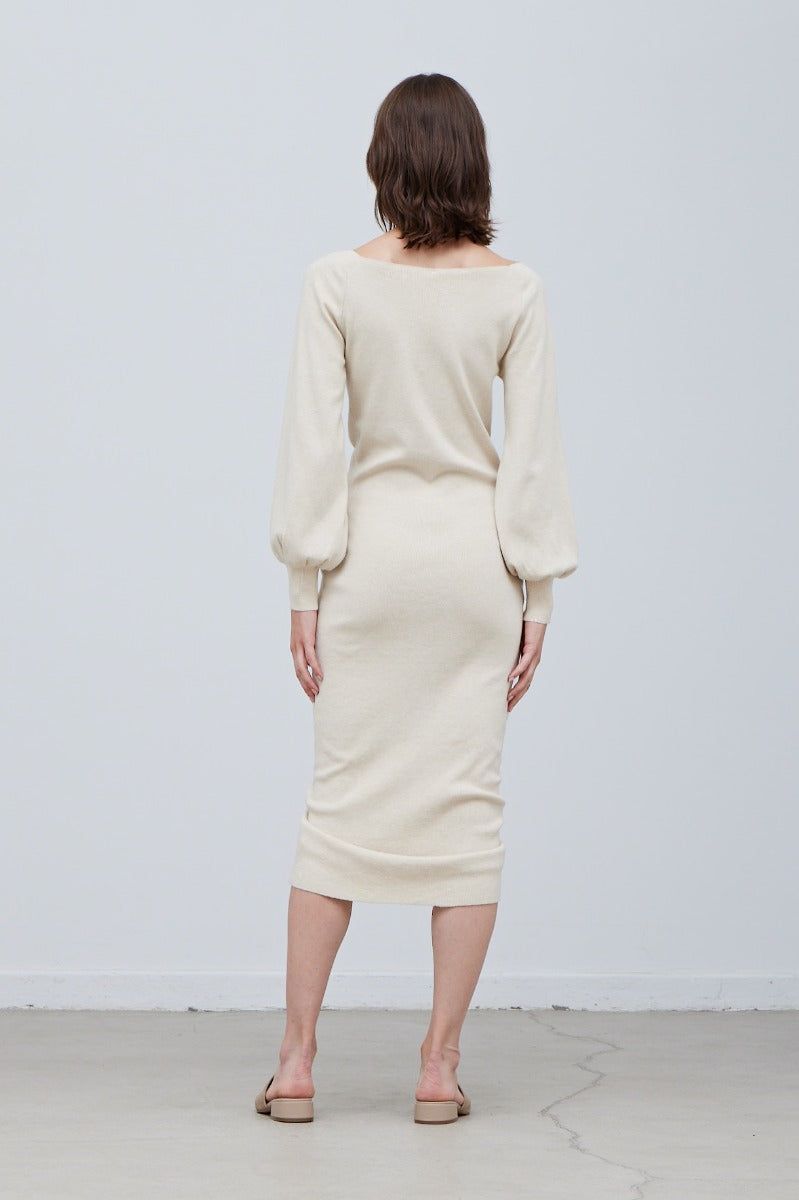 Back view of long sleeve sweater midi dress with smooth knit finish and fitted shape