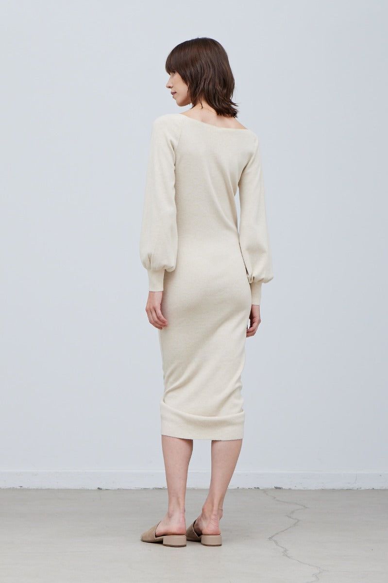 Three-quarter view of shirred knit midi dress highlighting waist-defining front gathering