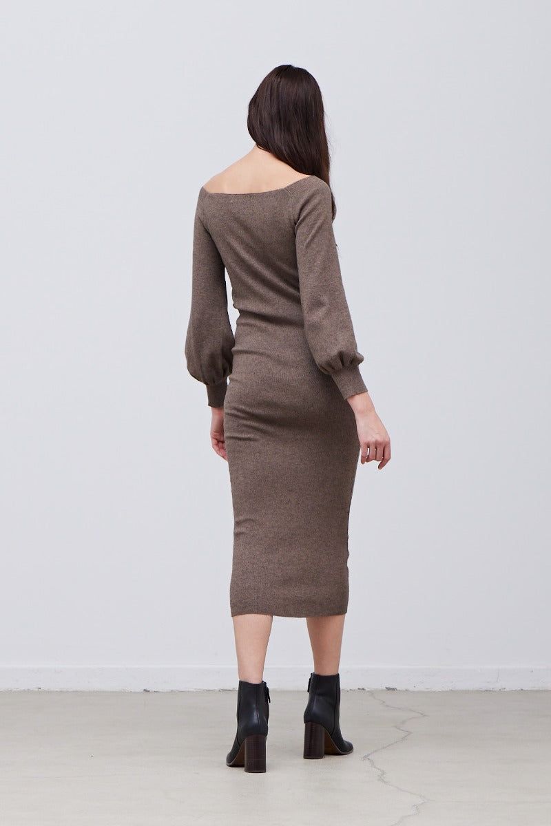 Side view of knit midi dress showing side shirring and body-contouring fit