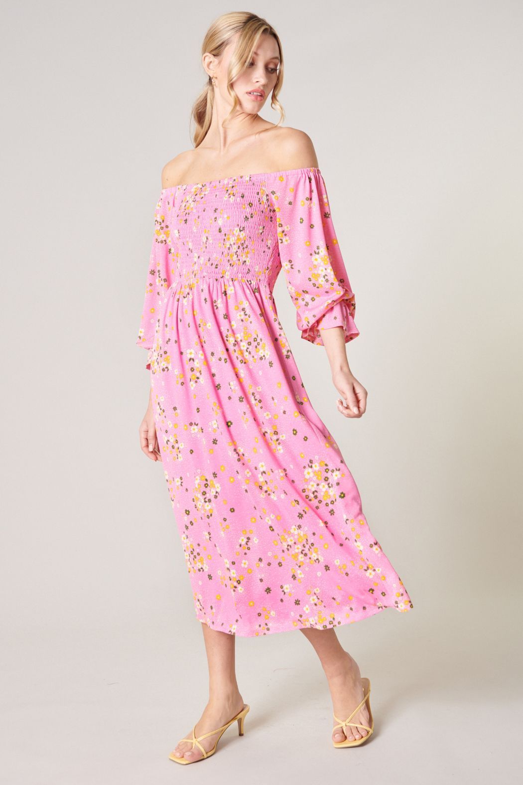 Three-quarter front view of Sugarlips Spring Dream pink floral midi dress with an off-shoulder neckline