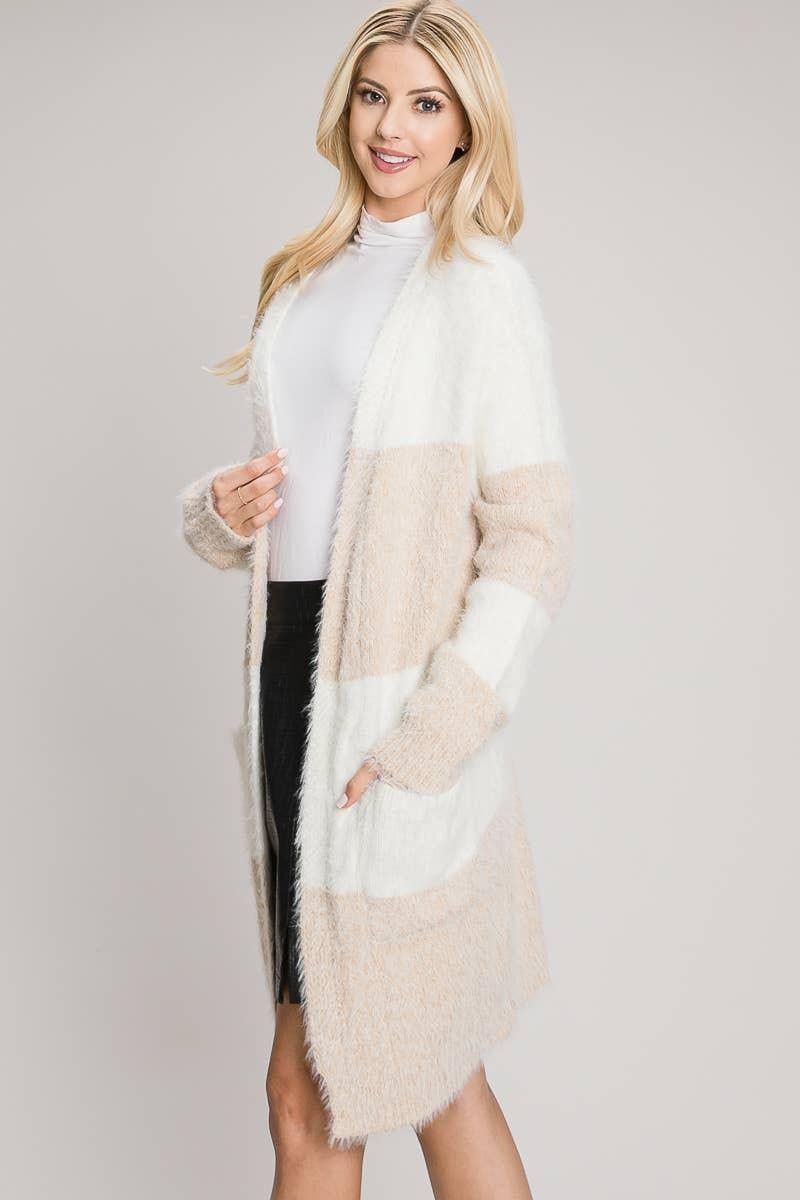 Angled view of the Tan color block cardigan with a front patch pocket and ribbed sleeve cuff.